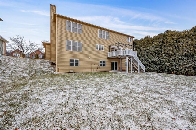 back of property featuring a patio and a wooden deck