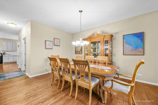 dining area featuring a chandelier and light hardwood / wood-style floors