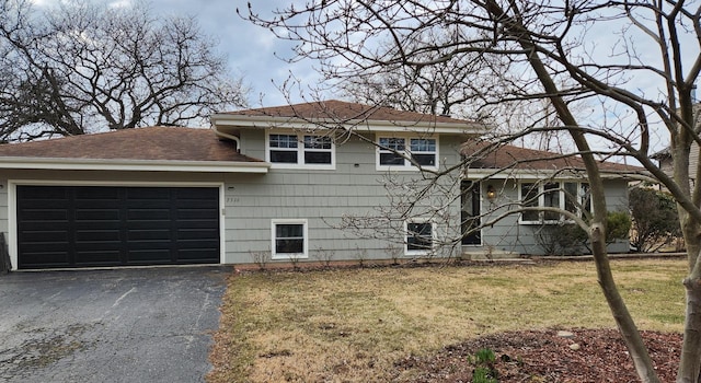 view of front of home featuring a garage and a front lawn