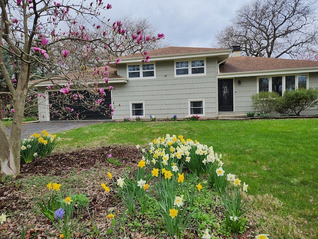 7516 Main St, Darien, IL 60561 - split level home featuring a front lawn, a chimney, and roof with shingles