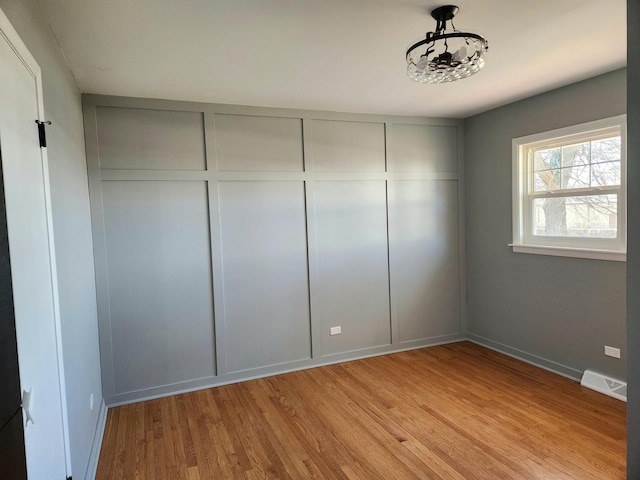 unfurnished bedroom with light wood-type flooring