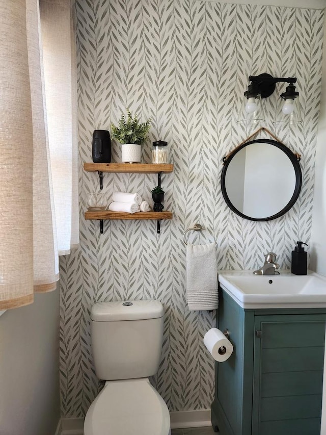 bathroom featuring vanity and toilet