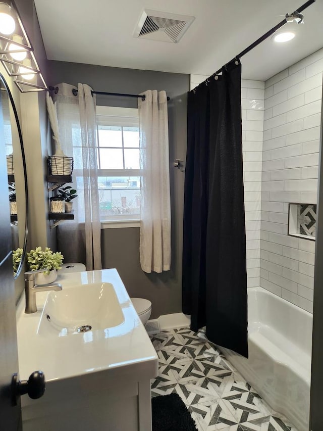 full bathroom with toilet, vanity, and shower / bathtub combination with curtain