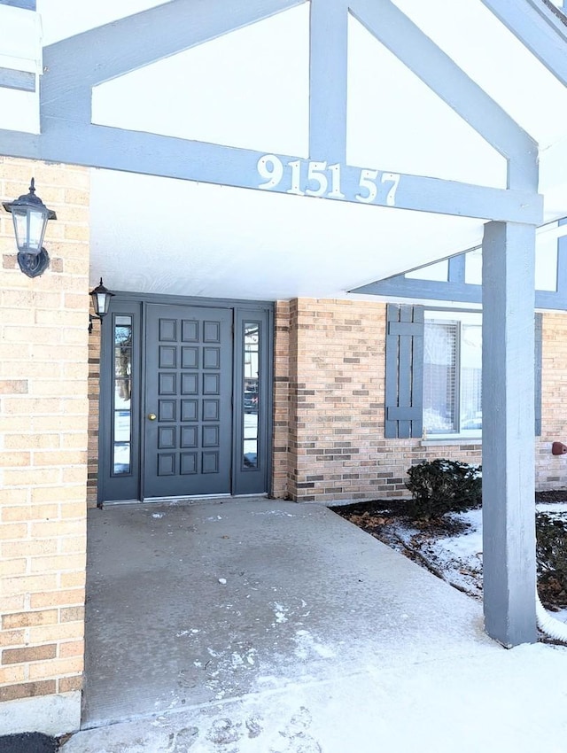 view of snow covered property entrance