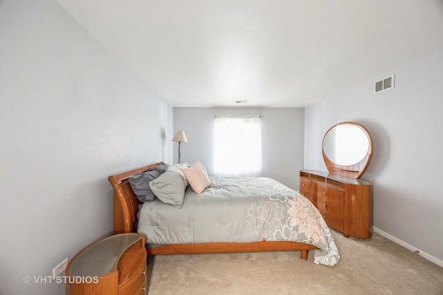 bedroom featuring light carpet, baseboards, and visible vents