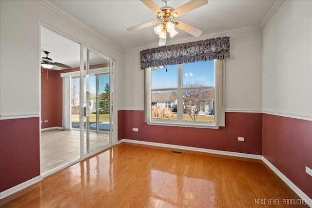 spare room with hardwood / wood-style floors, ceiling fan, and crown molding