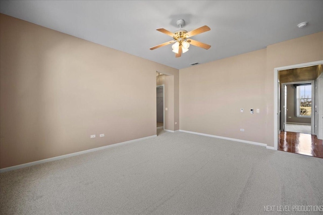 unfurnished room featuring ceiling fan and carpet