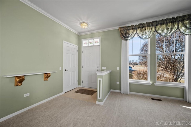 carpeted foyer with ornamental molding