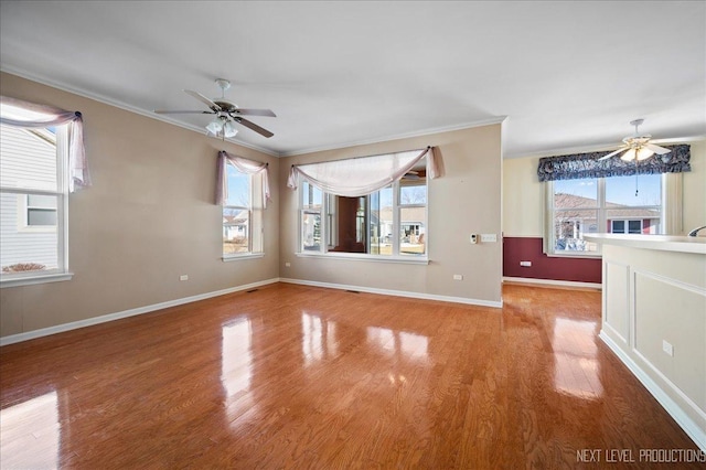 unfurnished room with ceiling fan, ornamental molding, and light hardwood / wood-style floors