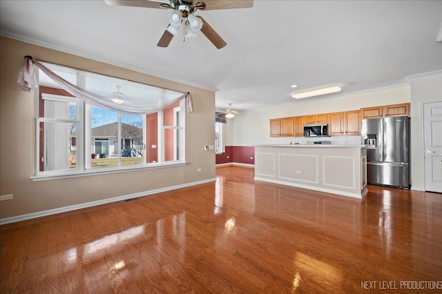 unfurnished living room featuring crown molding and light hardwood / wood-style flooring