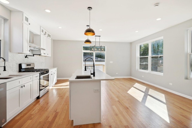 kitchen featuring stainless steel appliances, white cabinetry, tasteful backsplash, and sink