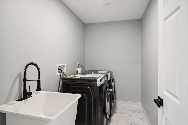 clothes washing area featuring independent washer and dryer and sink