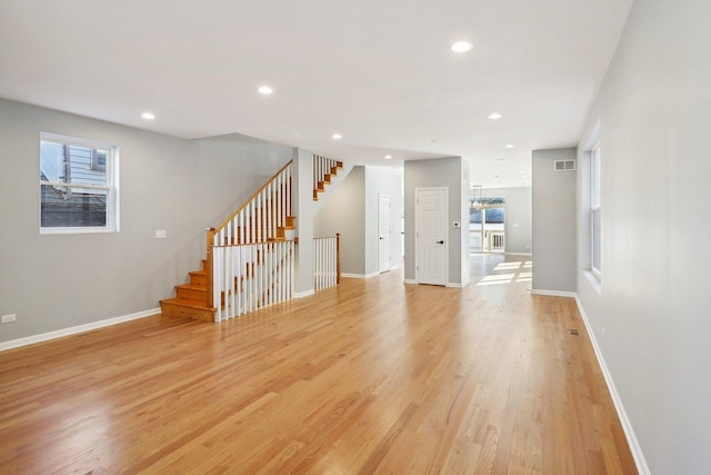 unfurnished living room featuring light wood-type flooring