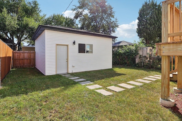 view of outbuilding with a yard