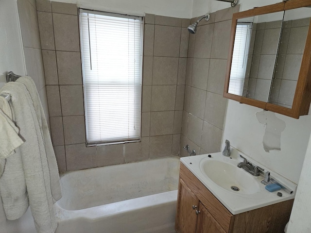 bathroom featuring vanity and tiled shower / bath