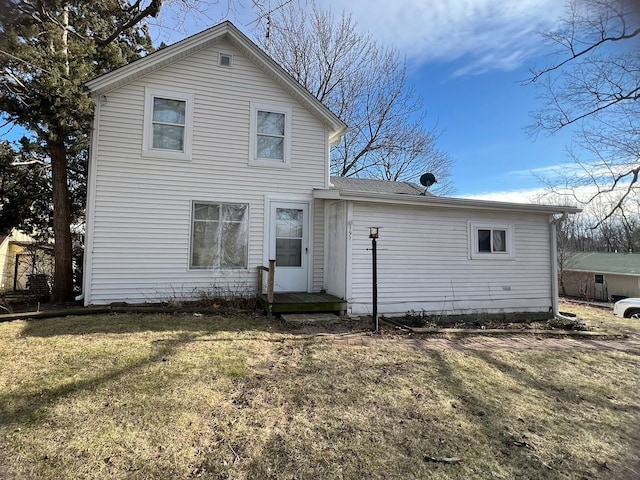 back of house with a yard