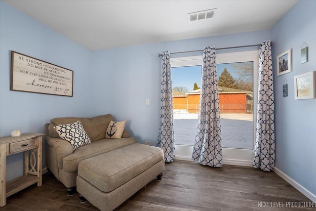 sitting room with dark wood-type flooring