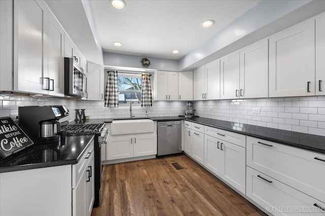 kitchen featuring sink, stainless steel appliances, and white cabinetry