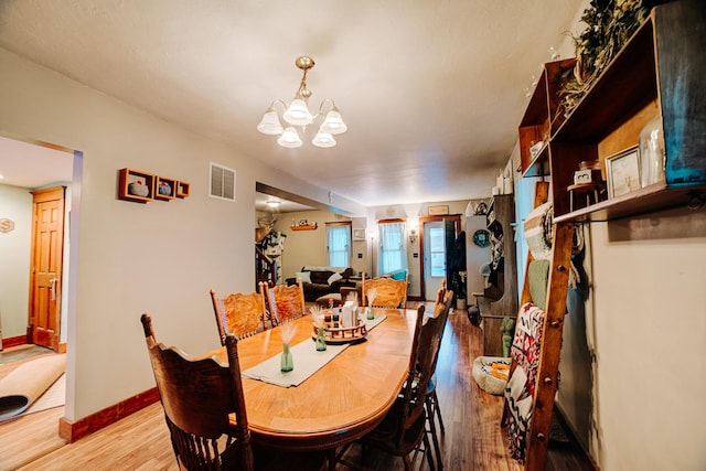 dining space featuring a chandelier and hardwood / wood-style floors