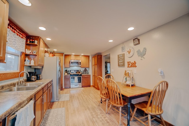 kitchen featuring light wood-type flooring, appliances with stainless steel finishes, and sink