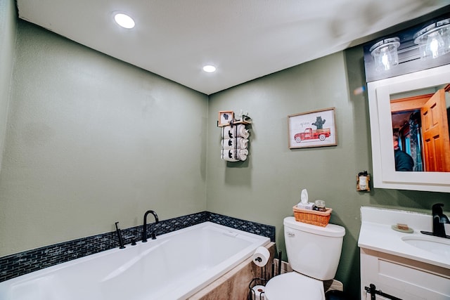 bathroom featuring tiled bath, toilet, and vanity