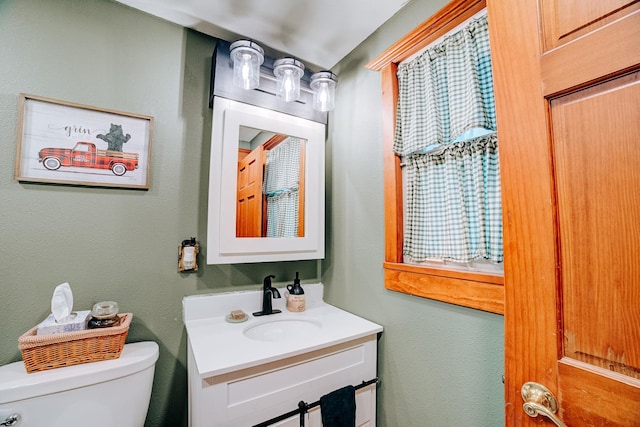 bathroom featuring toilet and vanity