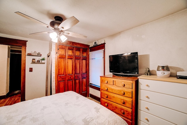 bedroom with ceiling fan and a closet