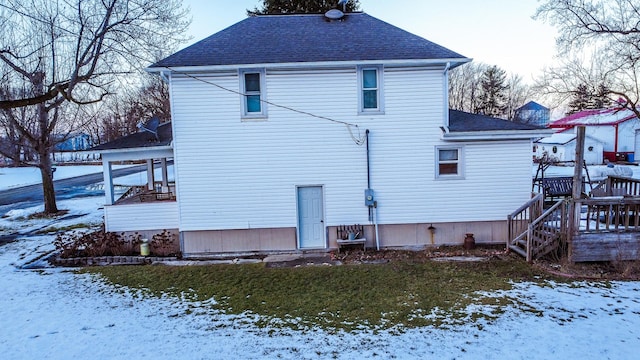 snow covered property with a lawn