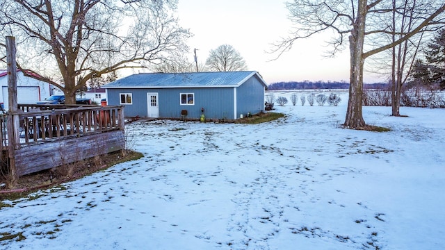 view of snow covered back of property