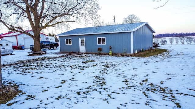 view of snow covered back of property