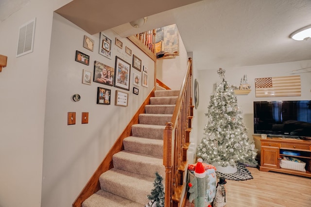 stairway featuring hardwood / wood-style flooring