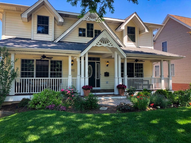 view of front facade featuring covered porch, ceiling fan, and a front lawn