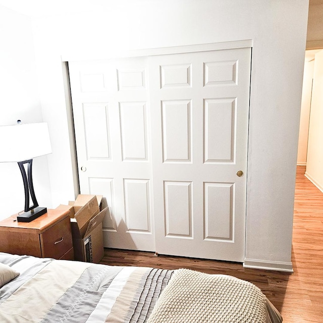 bedroom with a closet and dark hardwood / wood-style floors