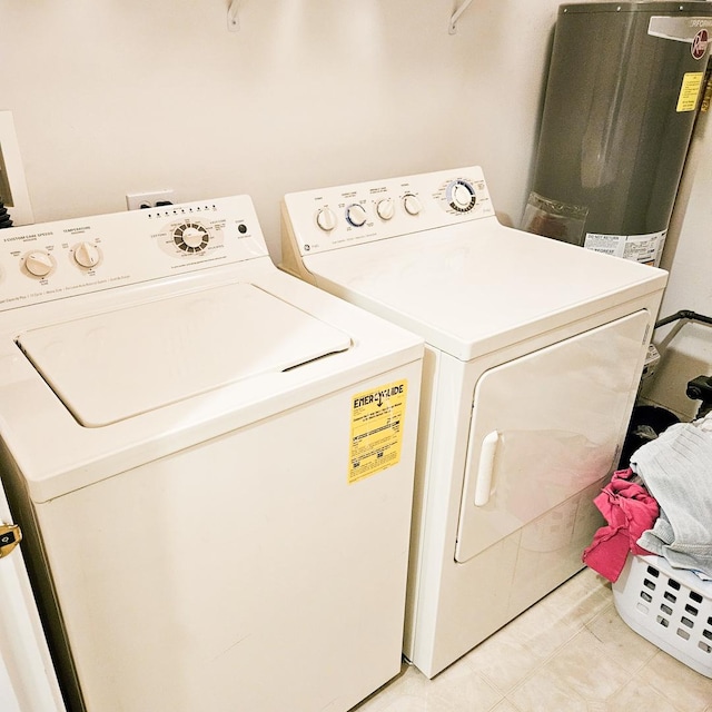 laundry area with washing machine and dryer and gas water heater