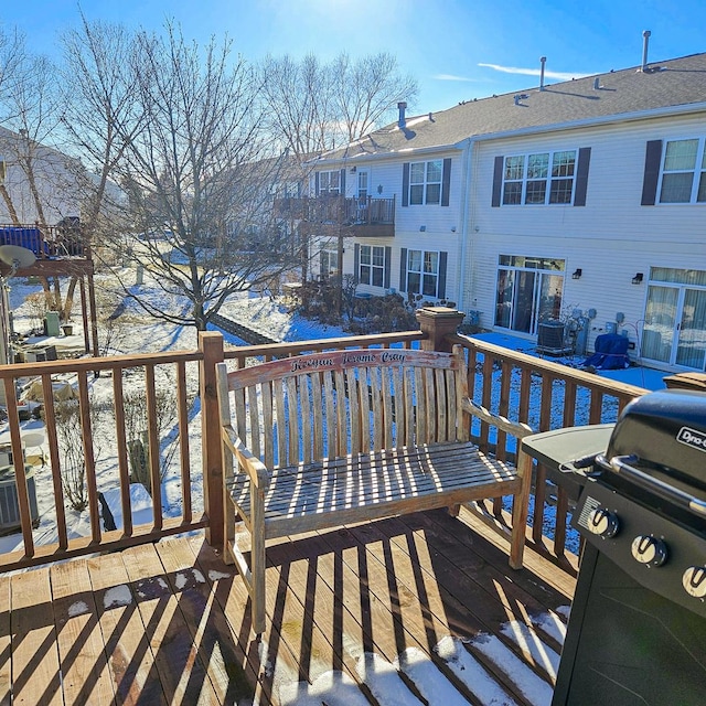 snow covered deck featuring grilling area