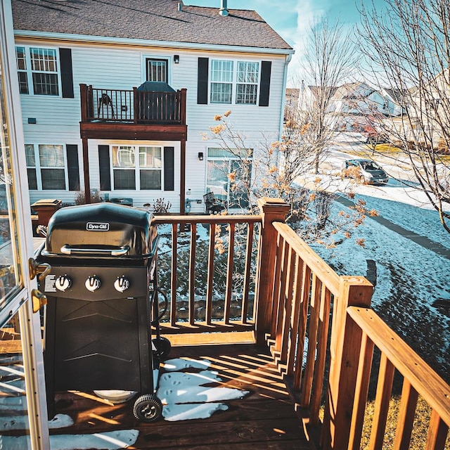 snow covered deck featuring area for grilling