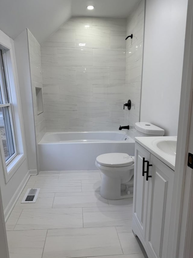 full bathroom with vanity, toilet, and tiled shower / bath