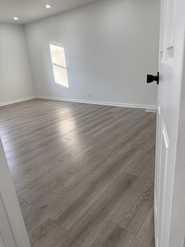 spare room featuring dark wood-type flooring