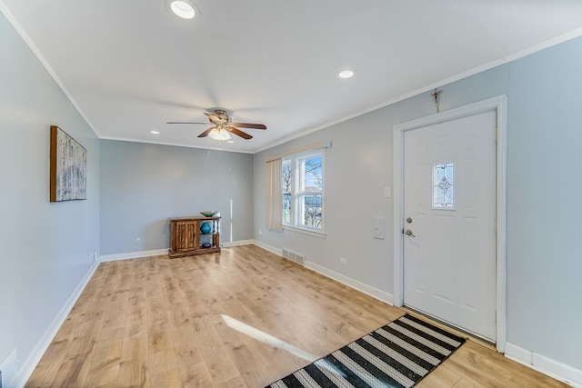 entryway featuring ceiling fan, light wood-type flooring, and ornamental molding