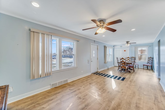 foyer featuring ceiling fan, light hardwood / wood-style floors, and ornamental molding