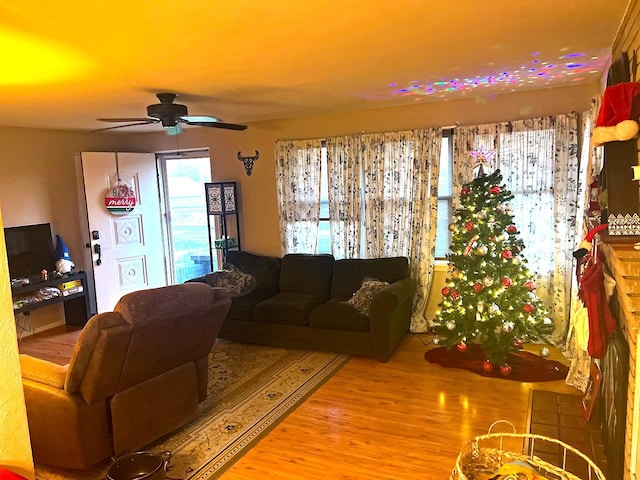 living room featuring light wood-type flooring and ceiling fan