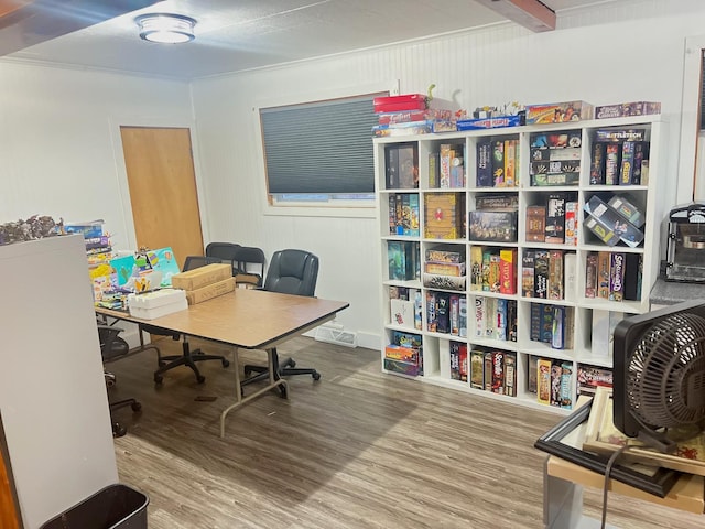 office area with beamed ceiling and hardwood / wood-style flooring