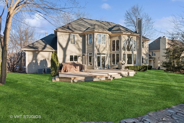 back of house featuring central AC unit, a lawn, a chimney, and a wooden deck