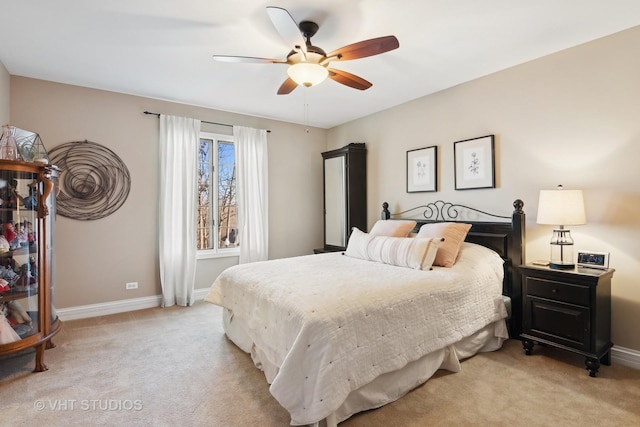 bedroom featuring baseboards, a ceiling fan, and light colored carpet