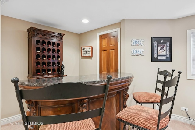 bar with carpet floors, a bar, recessed lighting, and baseboards