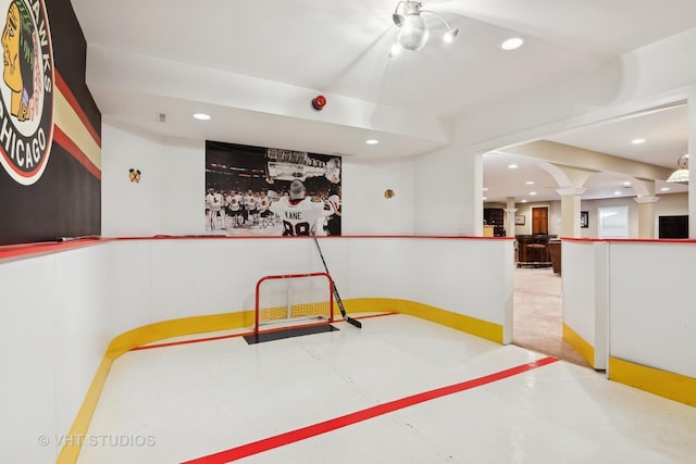 rec room with decorative columns, concrete flooring, and recessed lighting