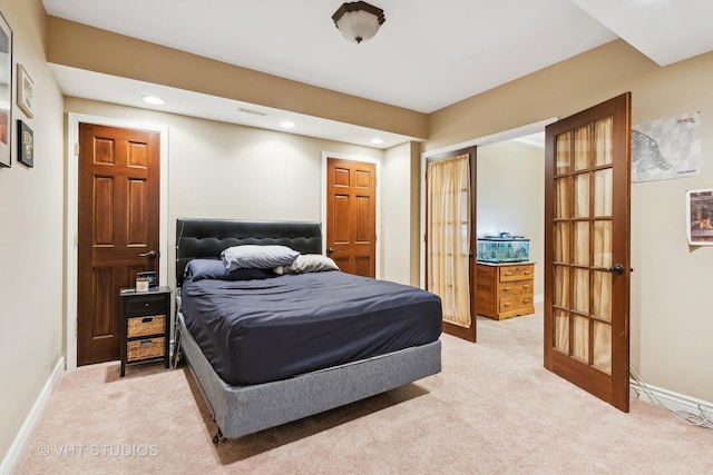 bedroom with light carpet, baseboards, french doors, a closet, and recessed lighting