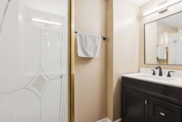 bathroom with a shower with door and vanity