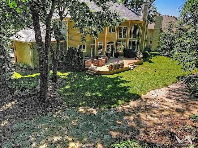 exterior space featuring a chimney and a yard