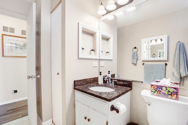 bathroom featuring vanity and toilet